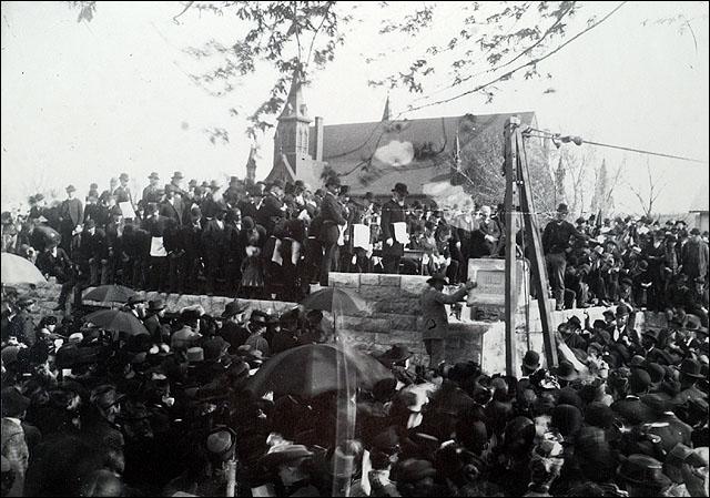 On April 18, 1890, 2,000 Lawrence school children gathered near the southeast  corner of 9th and Kentucky Streets to witness the laying of a cornerstone for a new high school building designed by J.G. Haskell. 